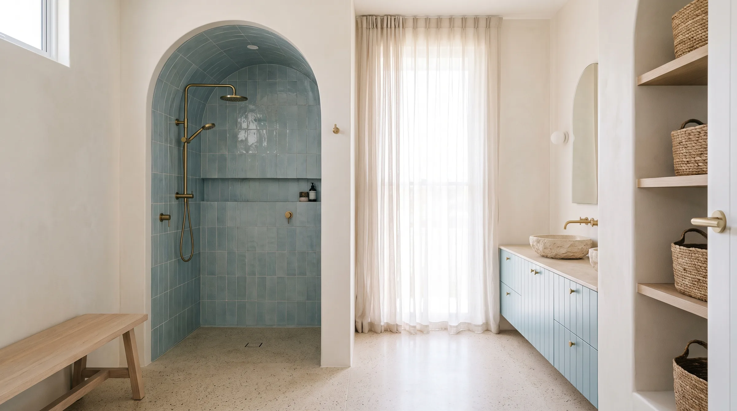 A finished bathroom renovation with sea blue tile, a timber vanity and brushed brass taps