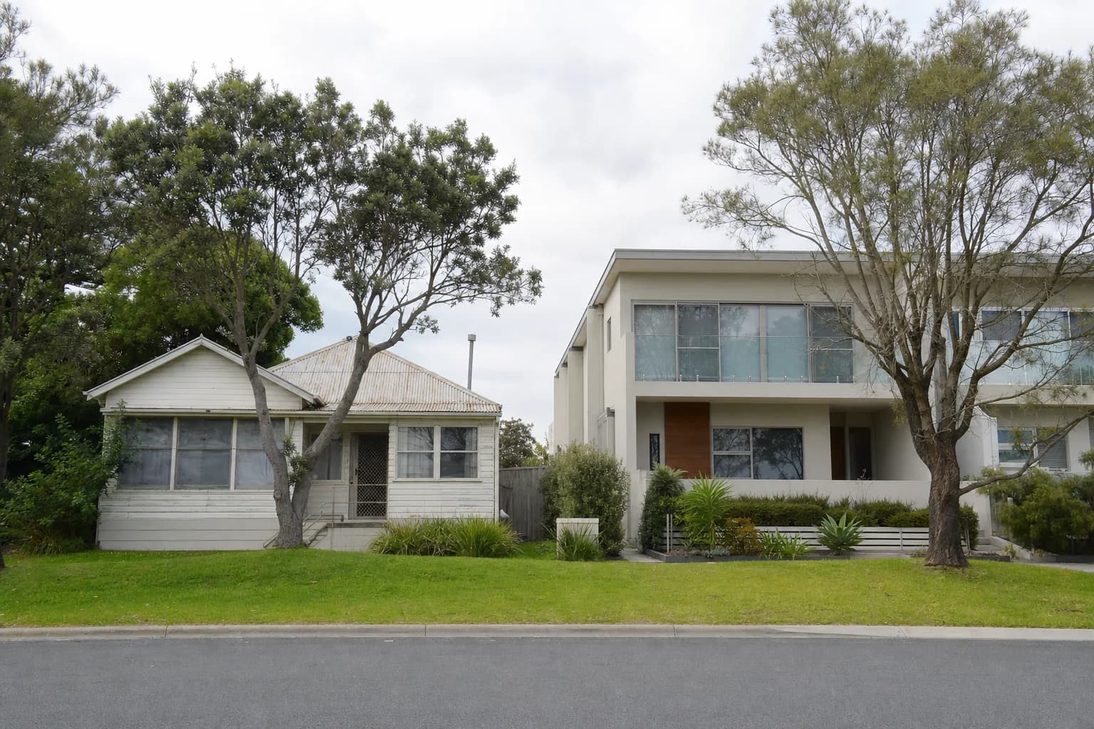 A Lennox Head street with an original low set beach shack beside a newer house
